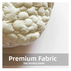 Detail of floral quilted pattern on cream nylon cloud shoulder bag for women