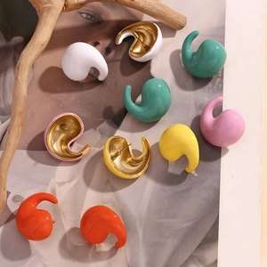 Macro shot of colorful enamel drop earrings with 18K gold plating on a fashion magazine