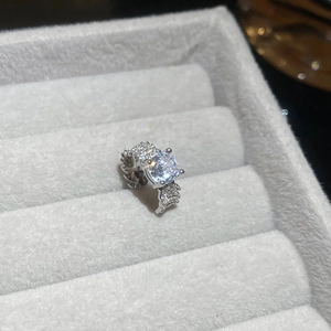 Macro shot of silver ring with large round zircon set in grey velvet jewelry box