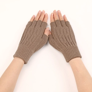 Detailed texture of brown cable knit fingerless gloves for cold weather arm protection
