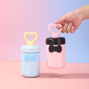 Close-up of portable creative straw cup with heart handle and bowknot detail