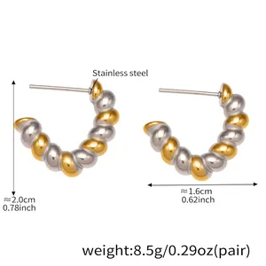 Detailed view of two-tone twisted stainless steel croissant earrings with 18k gold plating