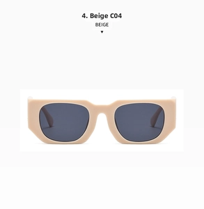 Detail view of oversized retro beige sunglasses with thick geometric frames and dark lenses