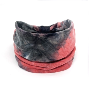 Macro detail of red and black tie-dye cotton sports headband with soft stretch texture
