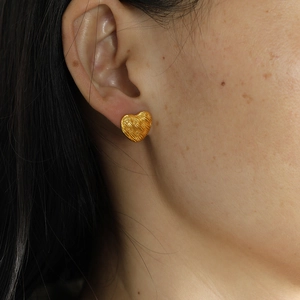 French vintage woven heart earrings in gold finish worn by a model for elegant styling