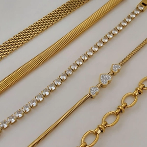 Detailed set of five gold plated stainless steel bracelets with tennis chain and heart charms