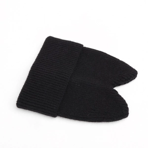 Detail of black knitted cat ear beanie with textured ribbed knit and pointed design