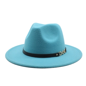 Detail of bright blue wool fedora hat featuring a black leather band and gold chain buckle