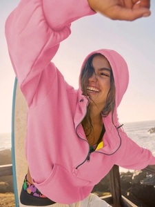 Close-up of pink half-zip hoodie with adjustable drawstrings and soft knit texture