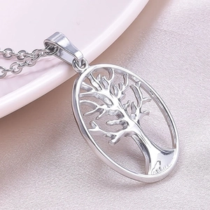 Detailed macro view of an oval stainless steel Tree of Life hollow pendant in silver finish
