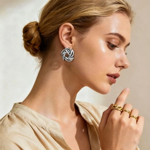Elegant silver hollow knot geometric earrings worn by model for a minimalist style