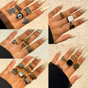 Collage of diverse silver and gold signet rings with punk style patterns and animal motifs