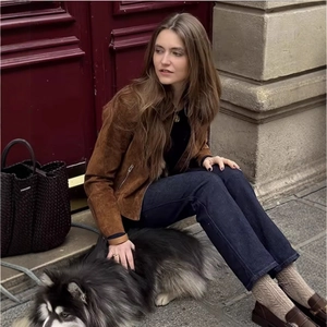 Women's brown suede zipper jacket with lapel collar shown in an outdoor street setting