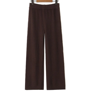 Detailed macro view of dark brown knit wide-leg pants showing premium textured fabric