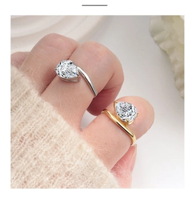 Close-up of s925 silver and gold rings with sparkling pear-cut zircon stones