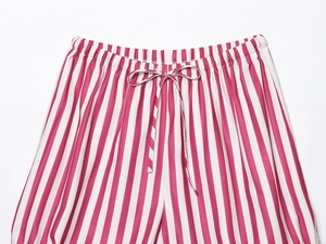 Detail of pink and white striped pajama pants featuring elastic drawstring waistband