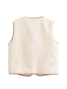 Detail view of the contrast brown trim on the back of this cream fleece vest