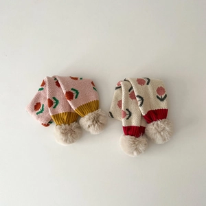 Cute knitted children's scarves with floral patterns and plush pompoms in pink and beige
