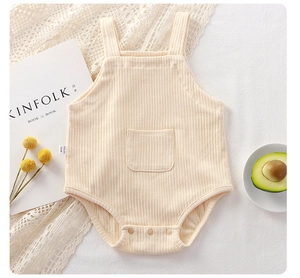 Detail of cream ribbed cotton baby bodysuit with square pocket and snap buttons
