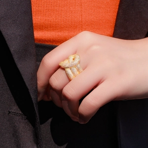 Statement knot ring with white cubic zirconia pavé set in gold, worn on a finger