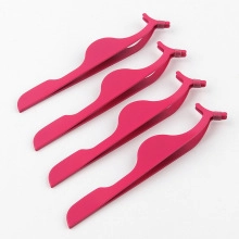 Detailed view of four pink false eyelash applicator tools on a clean white background