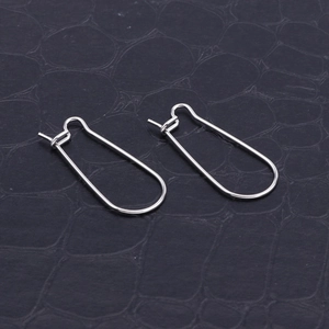 Minimalist silver titanium steel U-shaped earring hooks on textured leather background