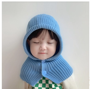 Detailed close-up of sky blue knitted baby balaclava with two matching resin buttons