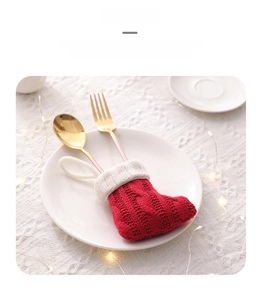 Close-up of red cable-knit Christmas mini stocking used as a festive cutlery holder set