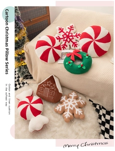 Various Christmas themed plush pillows including snowflake wreath and candy shapes