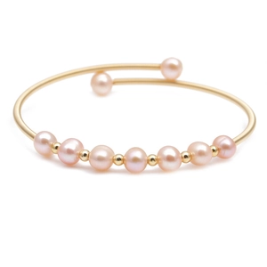 Gold-plated open bangle with nine pink freshwater pearls and small gold spacer beads