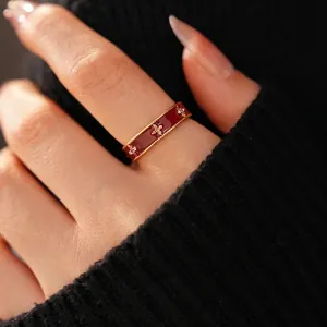18k gold plated ring with red enamel flower and zircon crystals shown on a finger