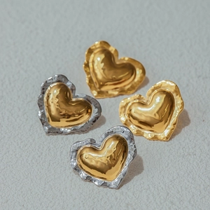 Elegant gold and silver heart stud earrings with unique textured metallic surface for women