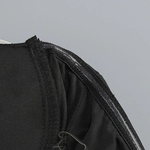 Close-up of internal anti-slip silicone strip on black strapless fishtail evening gown