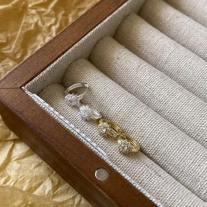 Macro detail of S925 sterling silver hoop earrings with pave set snowflake diamonds