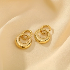 Polished 18K gold plated double hoop earrings on champagne silk background