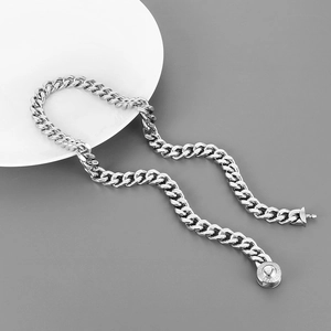 Macro detail of silver 10mm Cuban link chain with sparkling diamond-encrusted round clasp