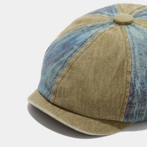 Detailed shot of vintage newsboy cap featuring khaki corduroy and patterned fabric stitching