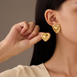 Minimalist polished gold heart stud earrings for women with a sleek 3D geometric design