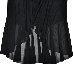 Detailed view of layered irregular black mesh hem and ruffled slit on a maxi dress