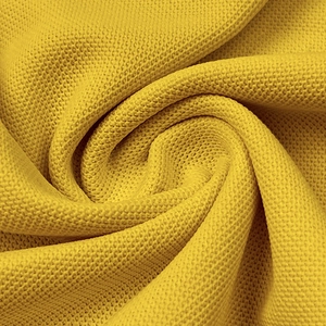 Macro shot of yellow honeycomb waffle texture on breathable polo shirt fabric