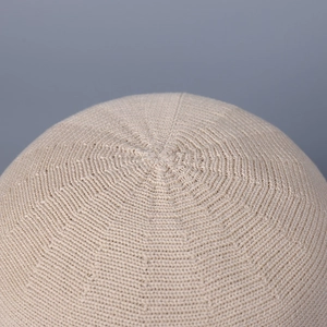 Close-up of beige fine knit sun hat showing detailed circular weave texture and soft material
