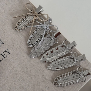 6-piece set of metal bow hair clips in gold and silver with rhinestones and chains