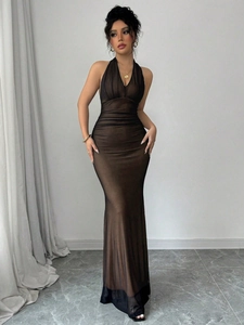 Detailed view of the dark brown sheer mesh fabric and pleated waist design of the dress