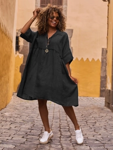 Chic black loose-fit polo collar dress with puff sleeves on a scenic European street