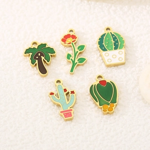Detailed macro view of five enamel plant charms featuring palm tree and cactus designs