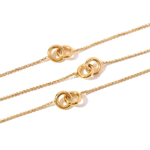 Close-up of interlocking double ring pendant on a gold-plated stainless steel chain