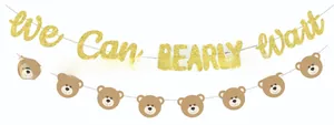 Close-up of glittery We Can BEARLY Wait banner and brown teddy bear face party bunting