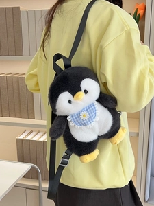 Cute penguin plush backpack for girls featuring a blue plaid bib and adjustable black straps