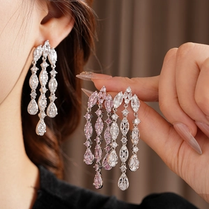 Detail of silver long tassel earrings featuring sparkling white and pink zircon crystals