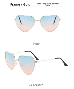 Detail of heart-shaped sunglasses featuring gold metal frame and blue-pink gradient lenses